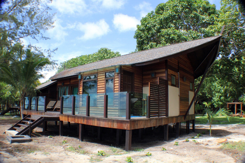 Beautiful wooden beach chalet at a Mataking luxury resort, nestled amongst lush tropical gardens just steps from the white sand shore.