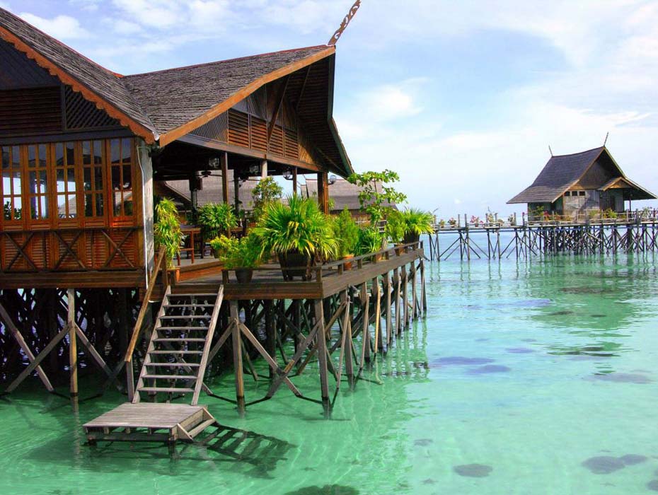 Picturesque view of the Kapalai water village resort, with its iconic wooden chalets stretching out over the calm, turquoise Celebes Sea.