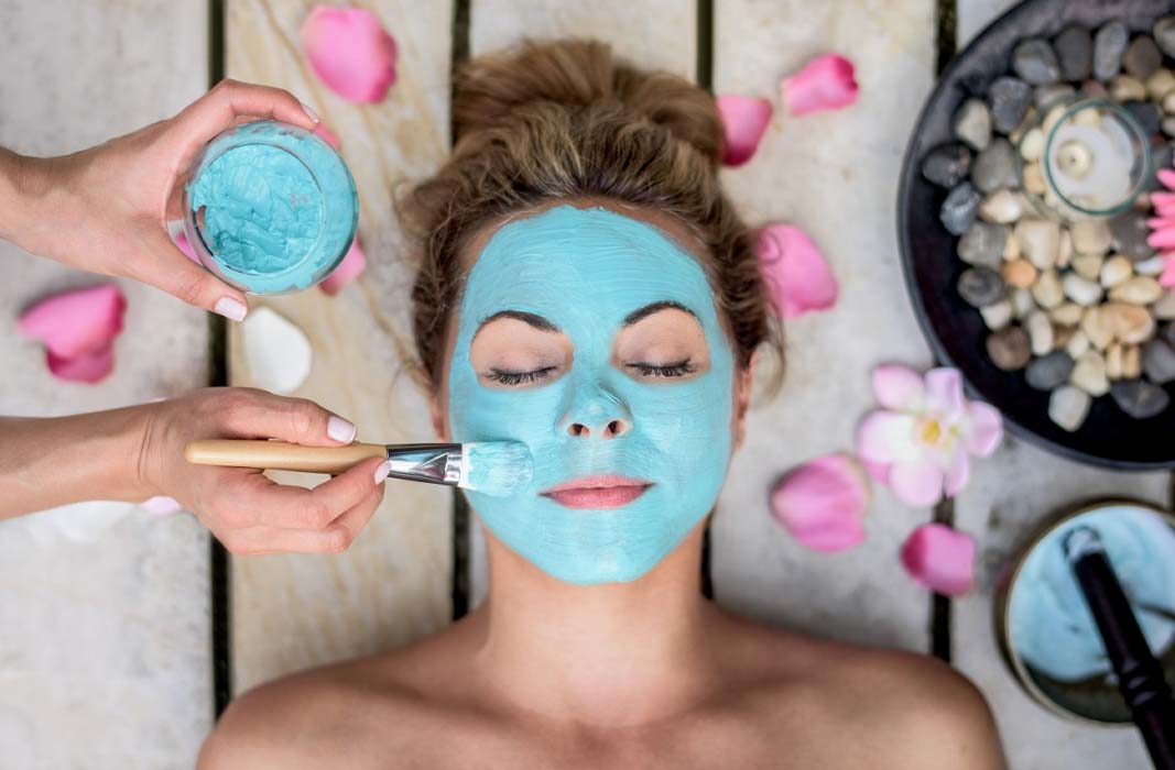 Guest enjoying a relaxing luxury facial treatment at a tranquil resort spa, perfect for rejuvenation after a day in the sun of Mabul island.