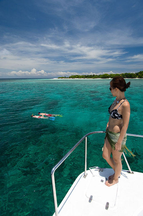 Fun and exciting banana boat ride on the clear turquoise sea, a popular water sports activity at Mabul island.