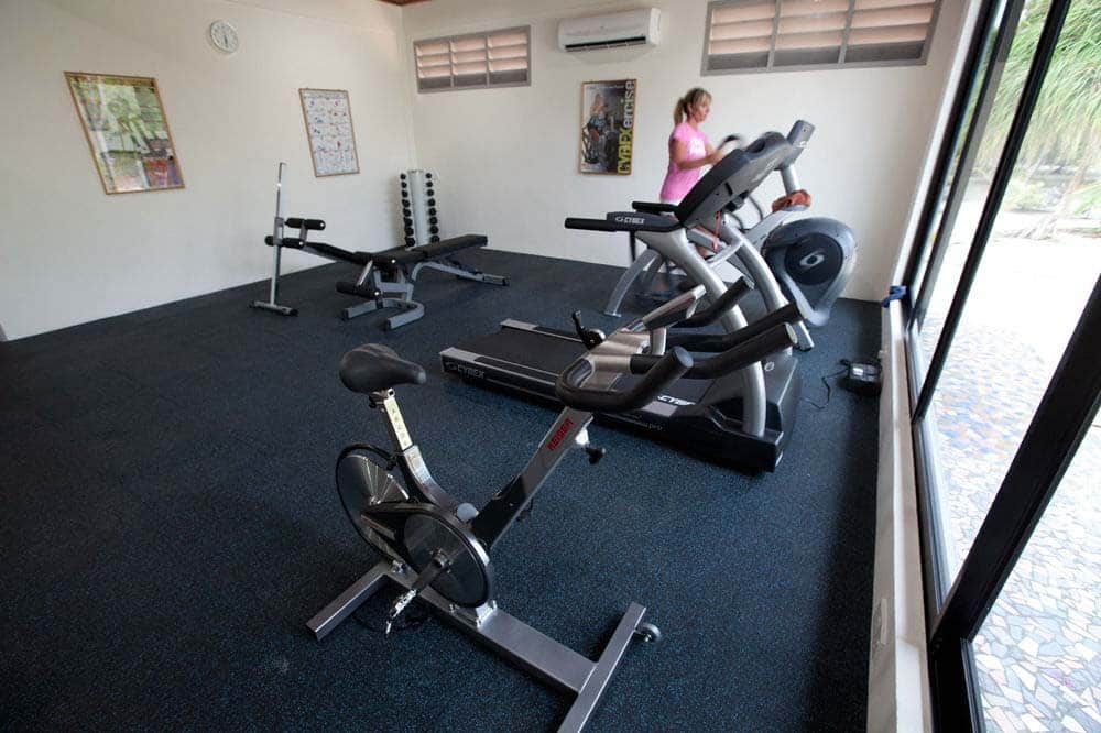 Well-equipped fitness center and gym at a resort on Mabul island, allowing guests to maintain their workout routine while on holiday.