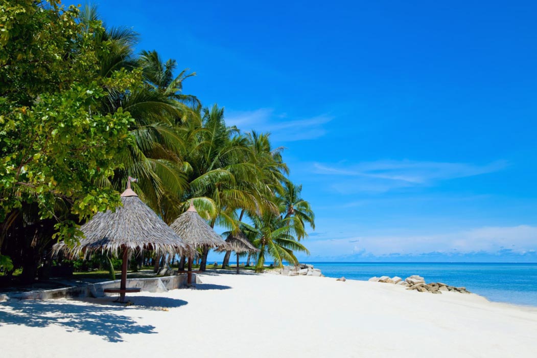 Beautiful white sand beach on Mabul Island at Sipadan-Mabul Resort, with white sandy beaches and turquoise sea.