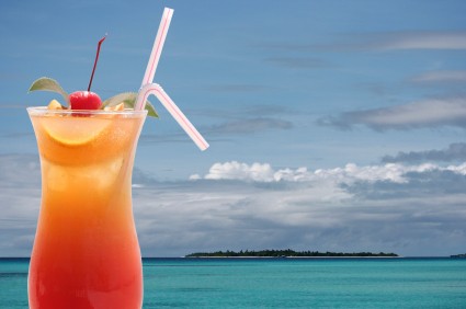 Colorful tropical cocktail served in a coconut on a beach bar, the perfect refreshment for a relaxing Mabul island holiday.