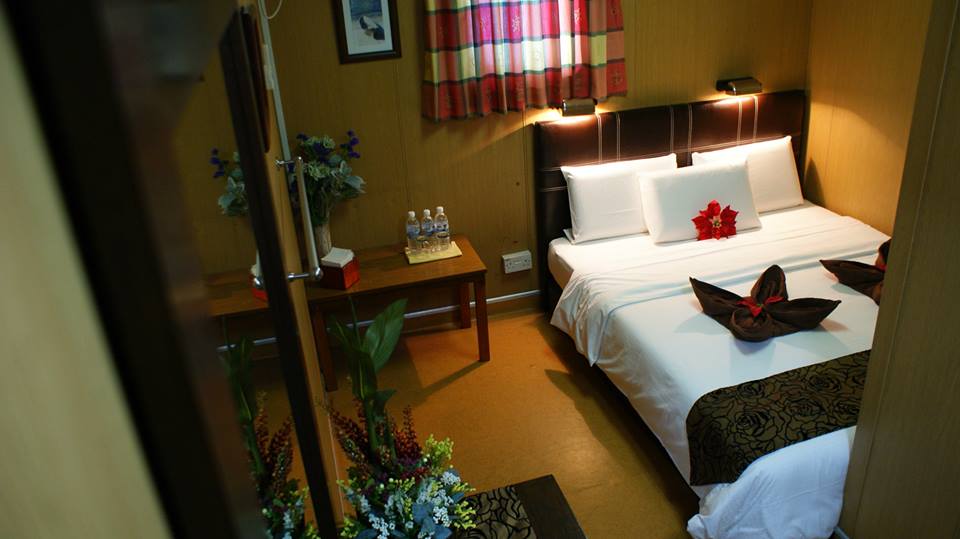 The interior of a standard twin/double room cabin at Seaventures Dive Rig, offering a comfortable and functional space for divers.