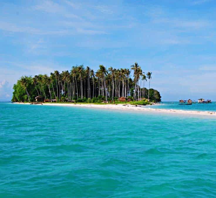 Idyllic Pulau Sibuan in the Tun Sakaran Marine Park, with its iconic long white sand spit and grove of coconut palm trees.