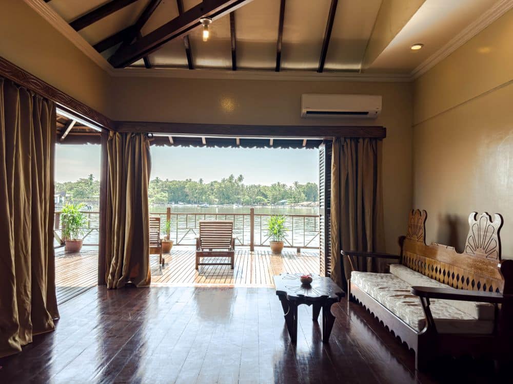 Spacious Deluxe Chalet at Sipadan Water Village, with an open-plan living area flowing onto a large private balcony with beautiful sea views.