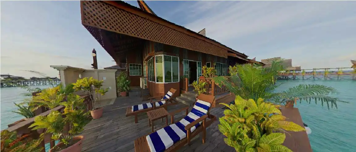 Expansive private sun deck of the Bougainvilla chalet at Mabul Water Bungalows, complete with lounge chairs for relaxing over the water and enjoying the seaviews.