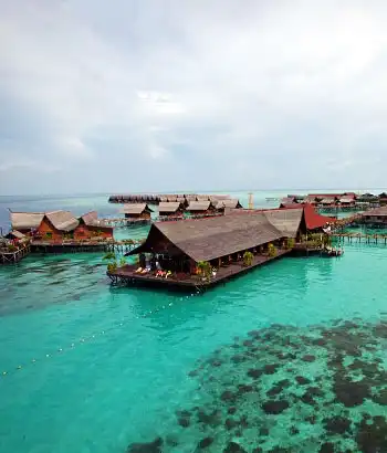 Breathtaking aerial skyview of the entire Kapalai resort, showing the network of chalets built over a shallow reef.