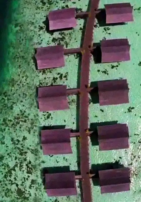 Beautiful overwater chalets of Kapalai resort, Drone view over the Celebes sea.