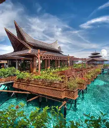 The fine-dining restaurant at Mabul Water Bungalows, showcasing stunning traditional architecture built over the turquoise sea.