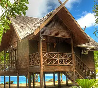Exquisite King Chalet at Mataking Island Resort, featuring traditional architecture and a prime beachfront location with stunning views of the Celebes Sea.