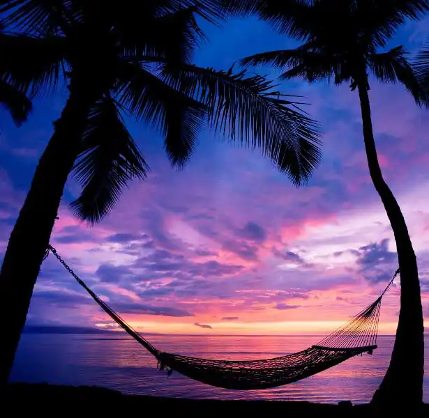 Relax in a beach hammock at our resort on Mabul island and enjoy a spectacular and colorful sunset over the Celebes Sea.